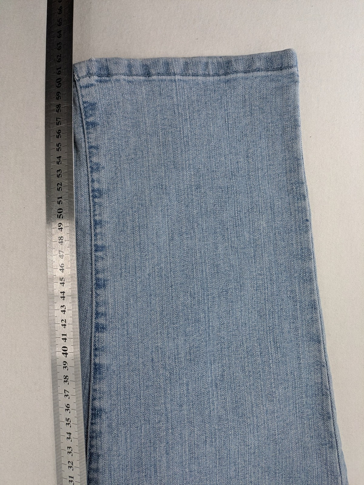 Capri blue straight jeans with 5-pocket design and embroidered details on back pockets.