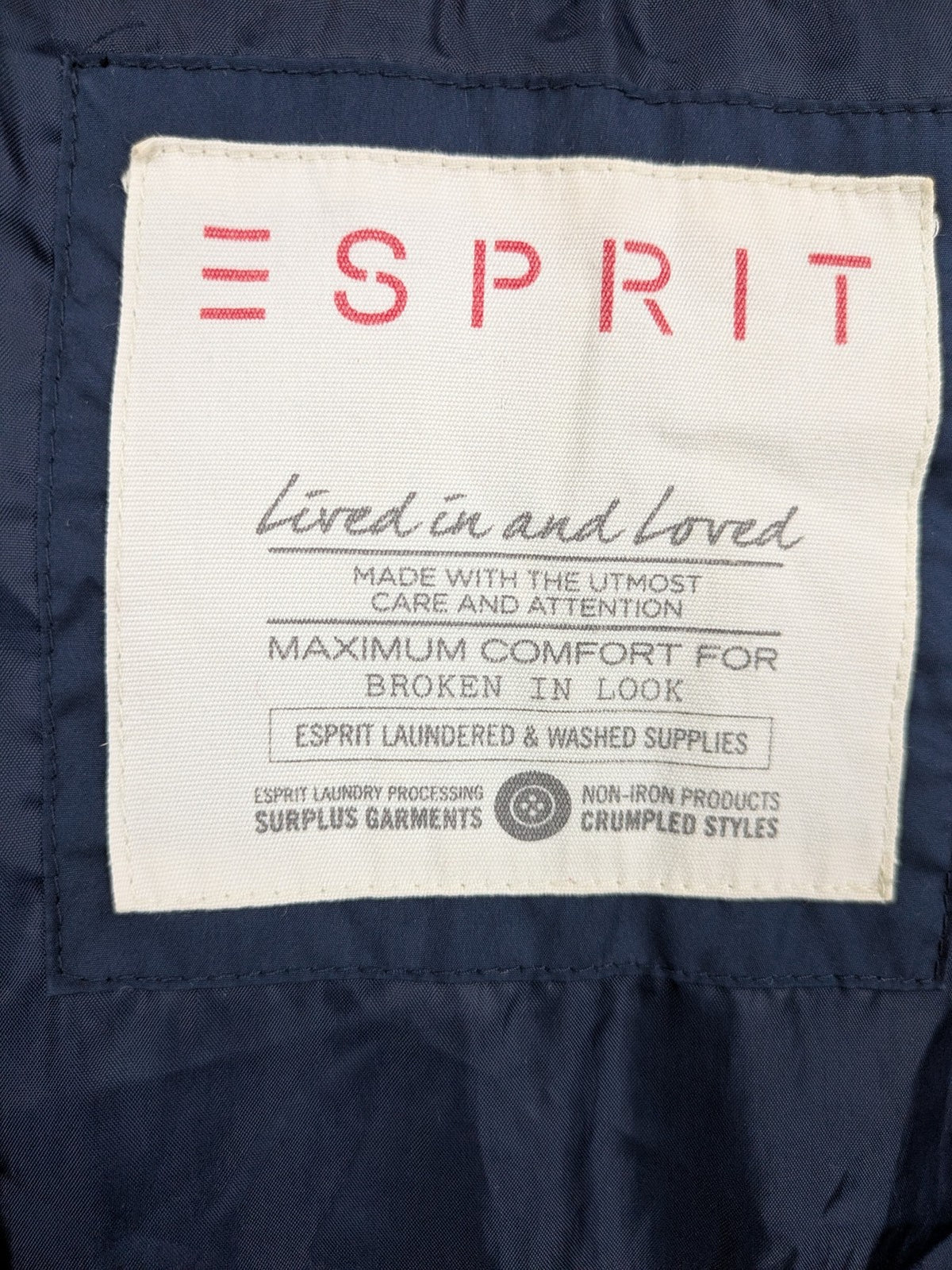 Esprit navy puffer jacket with belt, high collar, ribbed inner lining, and button placket.