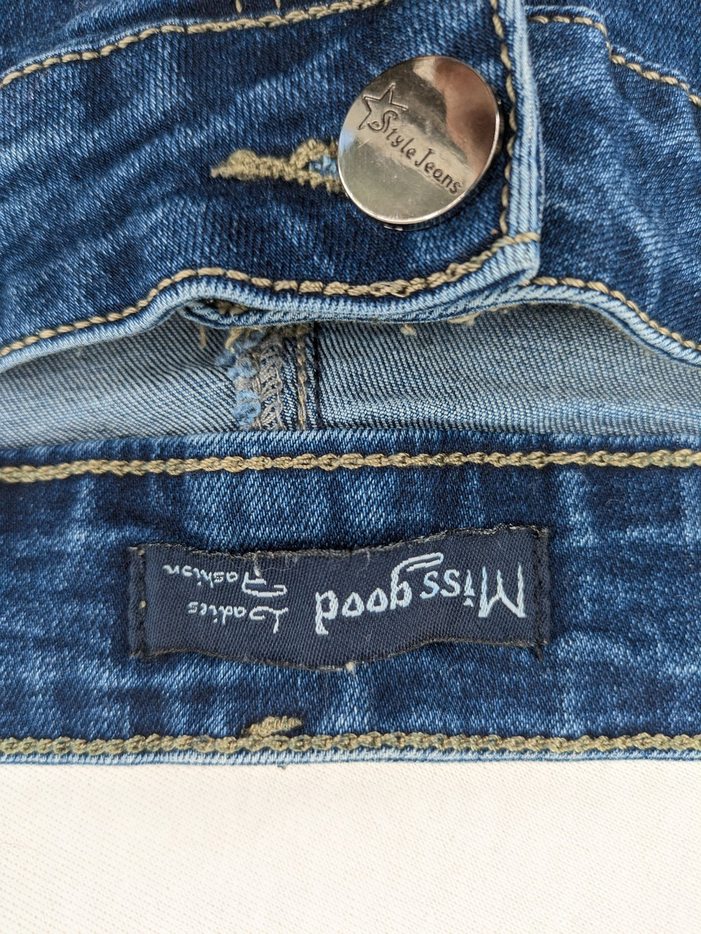 Miss Good blue straight jeans with 5-pocket design and decorative metal accent.