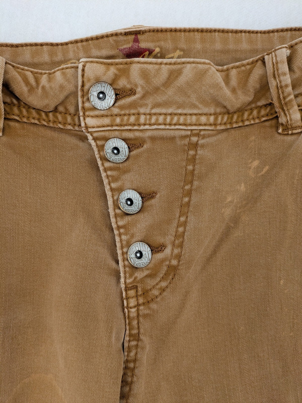 Buena Vista beige capri jeans with frayed hem and button fly detail.