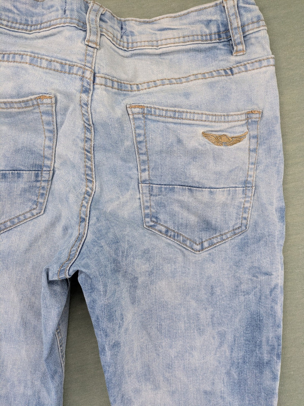 Arizona blue flare jeans with acid wash, button fly, and stretch denim material.
