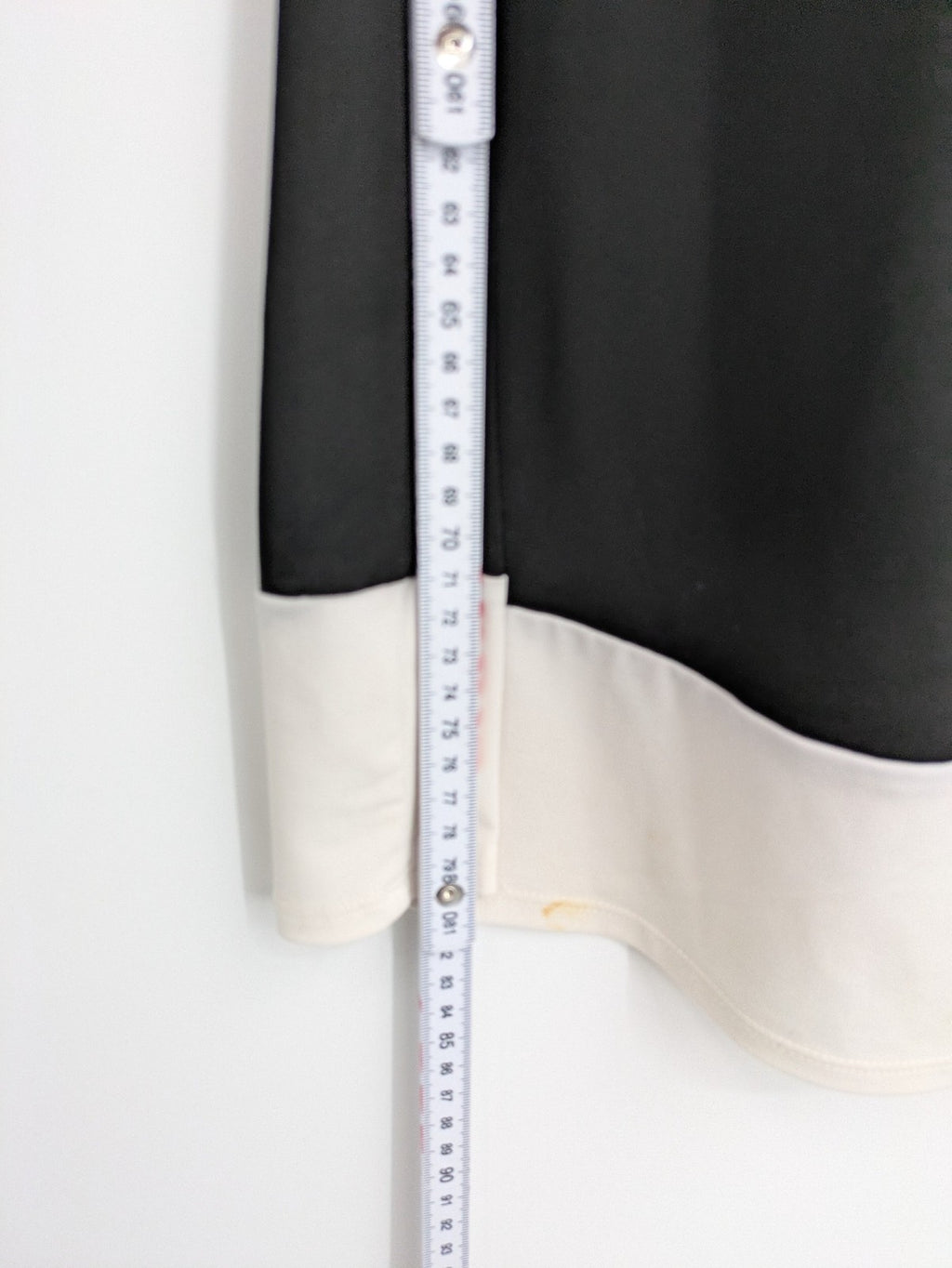En Focus Studio beige and black top, sleeveless with beaded neckline and tie detail.