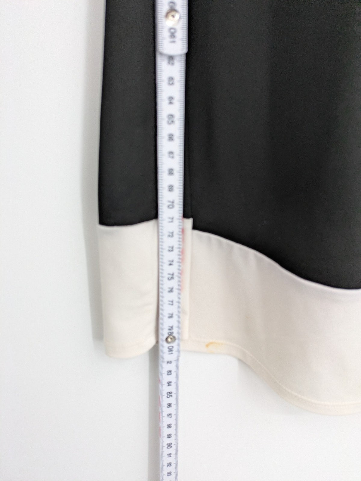 En Focus Studio beige and black top, sleeveless with beaded neckline and tie detail.