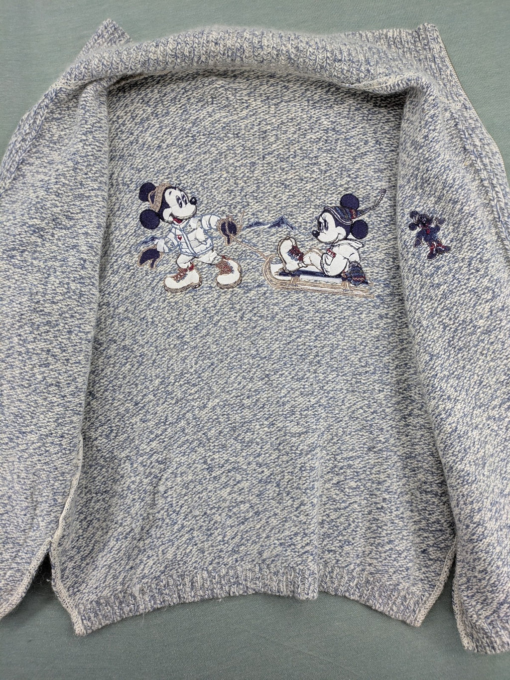 Disney blue turtle neck jumper with grey Mickey and Minnie Mouse embroidery, zip closure.