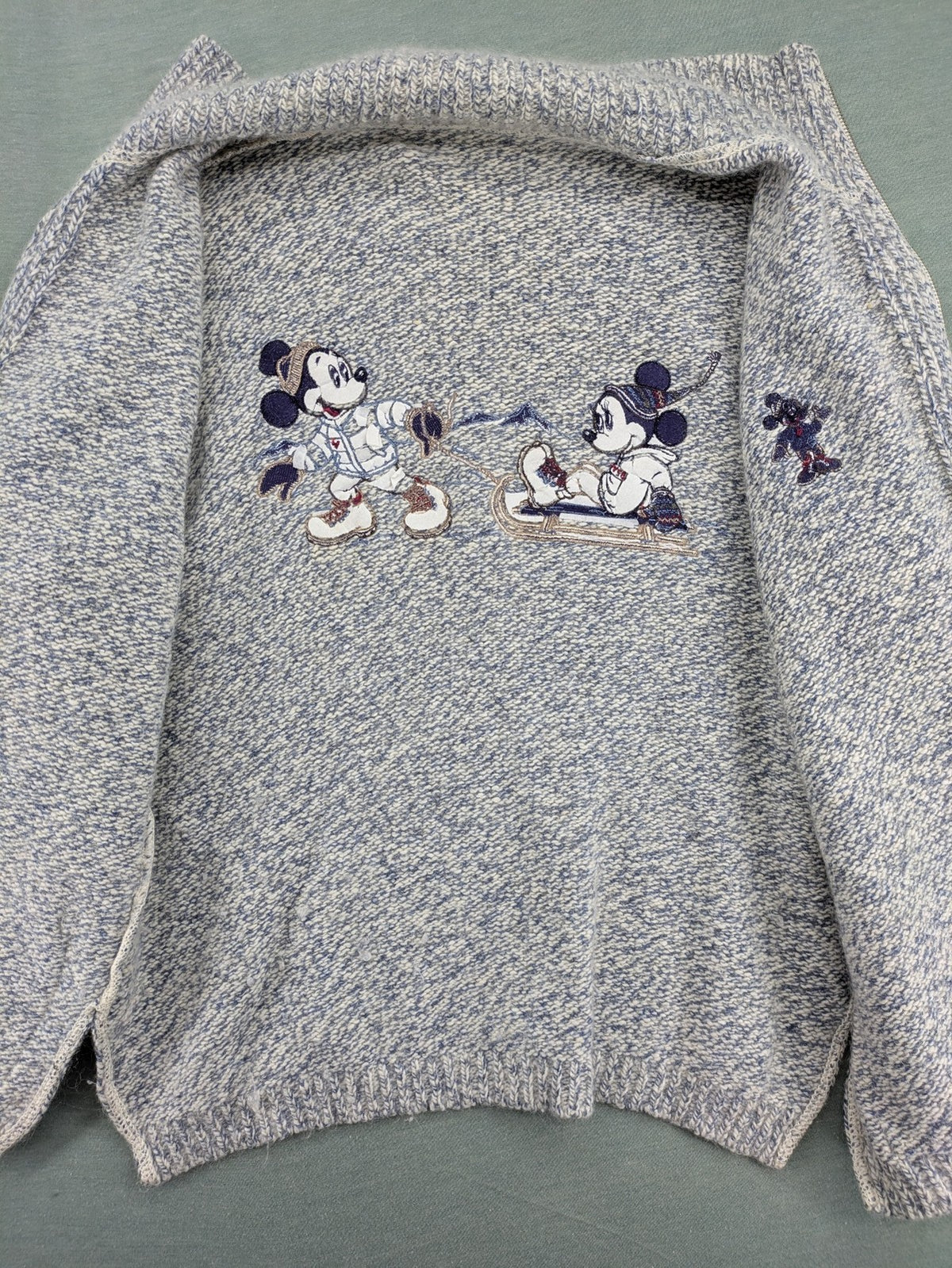 Disney blue turtle neck jumper with grey Mickey and Minnie Mouse embroidery, zip closure.