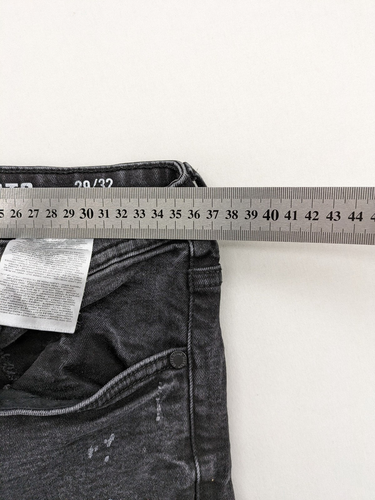 Black Squad skinny fit jeans black distressed ripped design with subtle paint splatter.