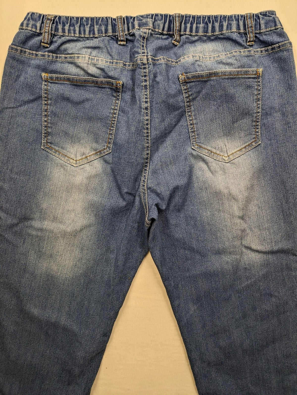 Rainbow blue straight jeans with elastic waistband and decorative knee stitching.