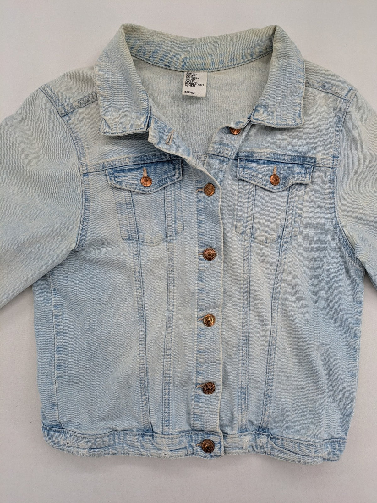 H&M denim jacket light blue classic trucker style with button placket and chest pockets.