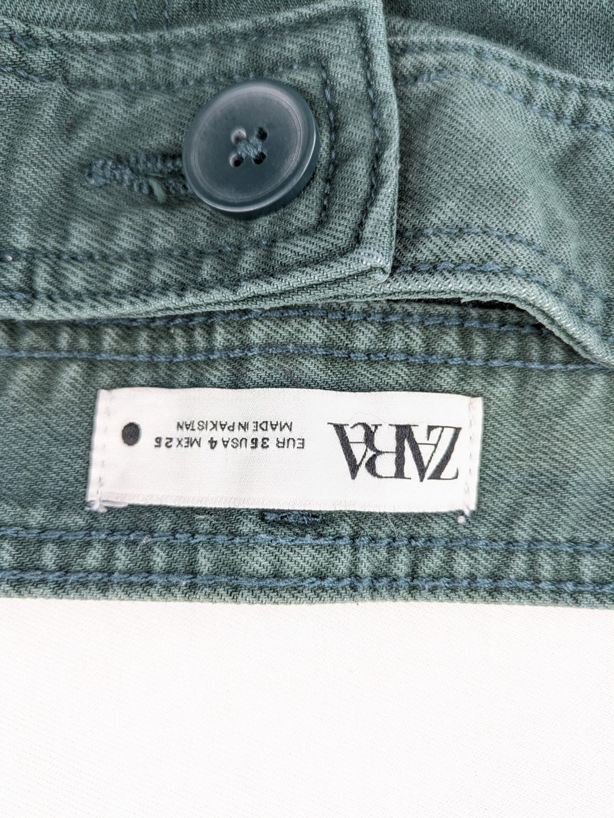 Zara green high waist wide leg jeans with frayed hem and button closure.