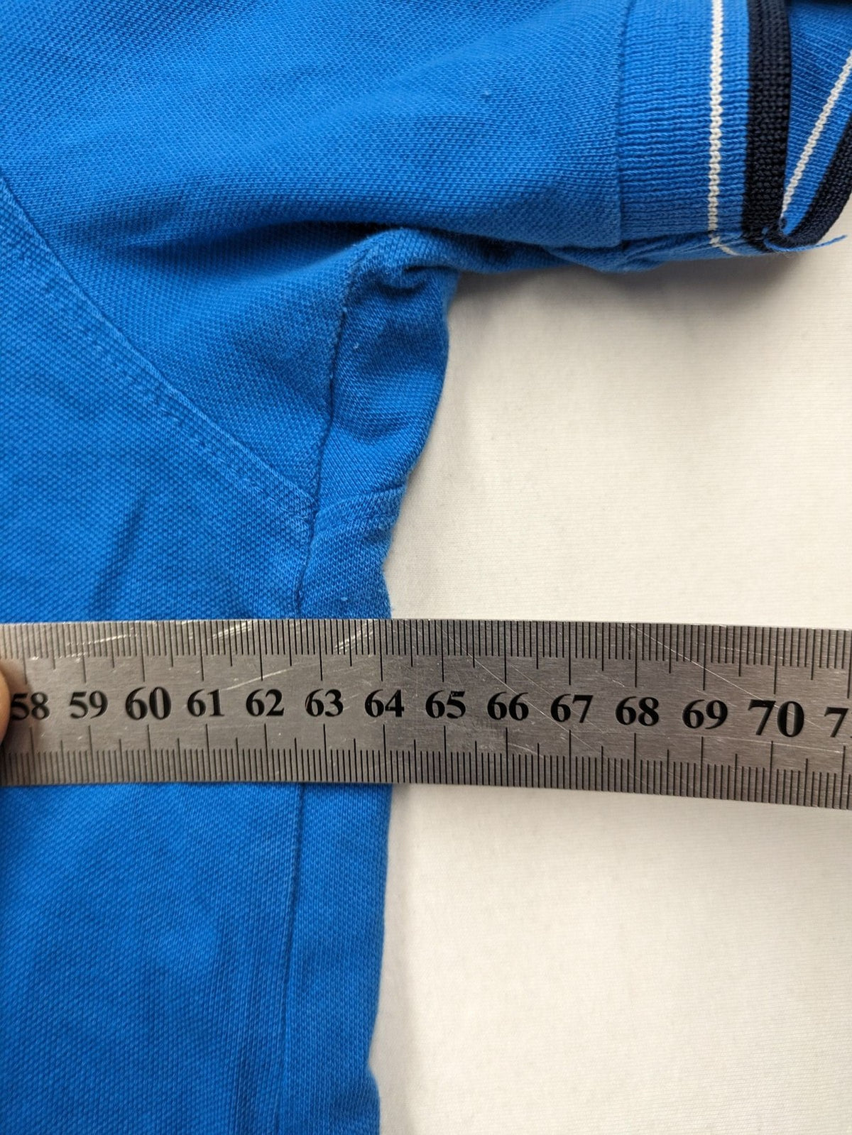 Tommy Hilfiger blue polo shirt with white stripes and embroidered logo on chest.