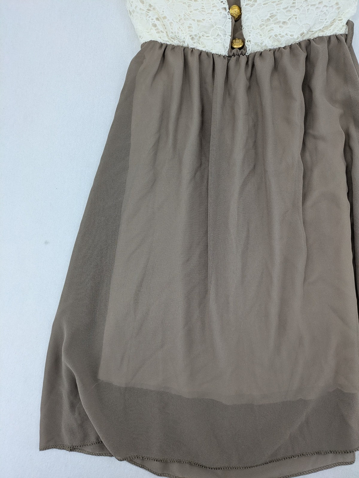 Creme bandeau summer dress in taupe with lace top and decorative gold buttons.