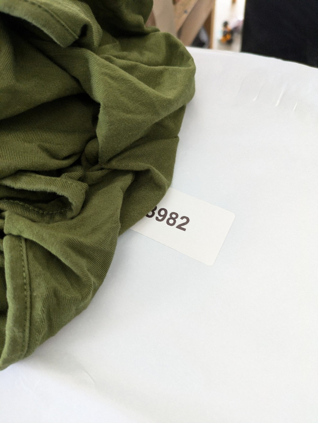 Bonprix green maternity dress with layered V-neck and empire waist design.