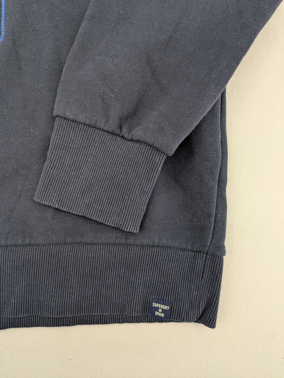 Superdry navy sweatshirt with embroidered tiger graphic and "JPN 54" chenille detail.