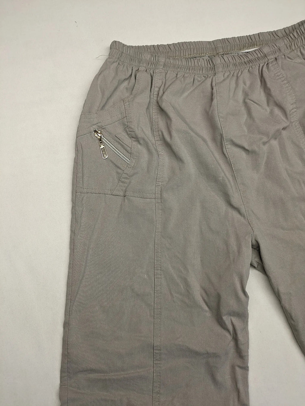 Cherry Berry khaki capri pants with elastic waistband and decorative buttons, featuring logo and zip pockets.