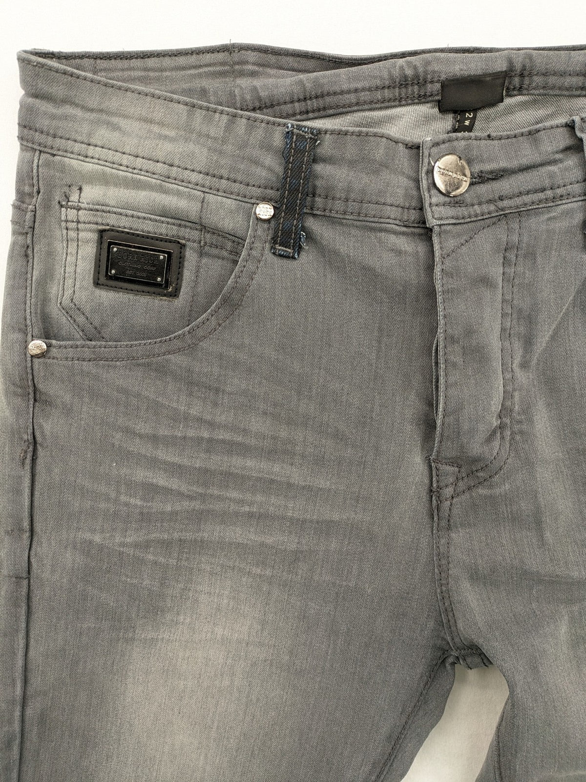 Born Rich grey slim fit jeans with button fly and washed denim texture.