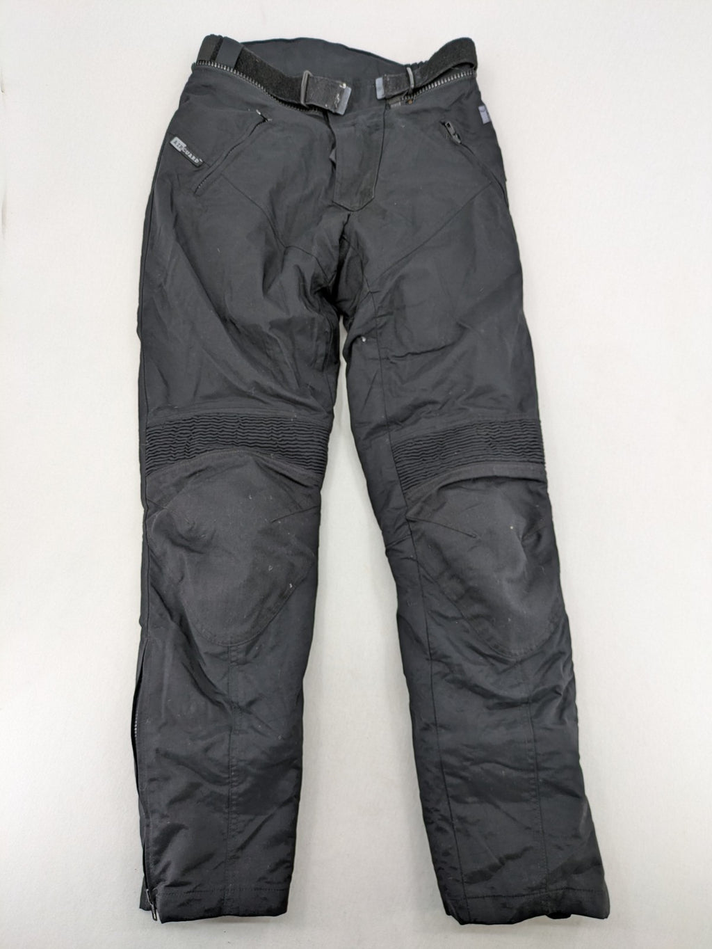 iXS black chaps with grey accents, waterproof textile, adjustable belt, reinforced knees.