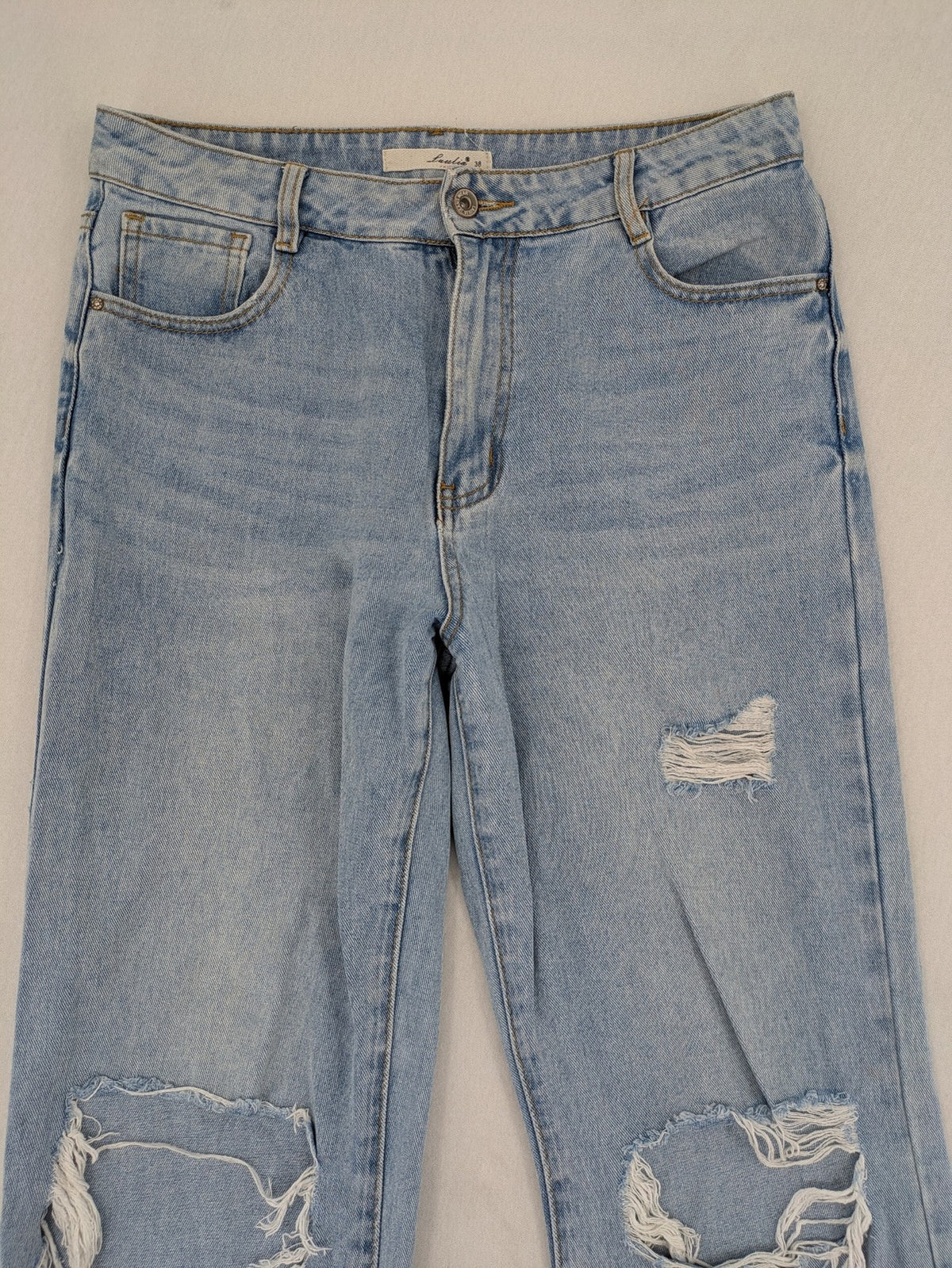 Laulia blue wide leg jeans with distressed knee rips and high waist design.