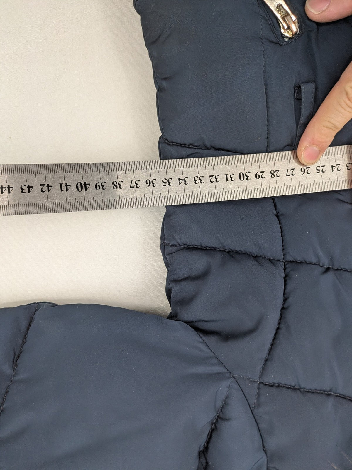 GEF cream coat with quilted design, fleece-lined hood, and faux fur trim.