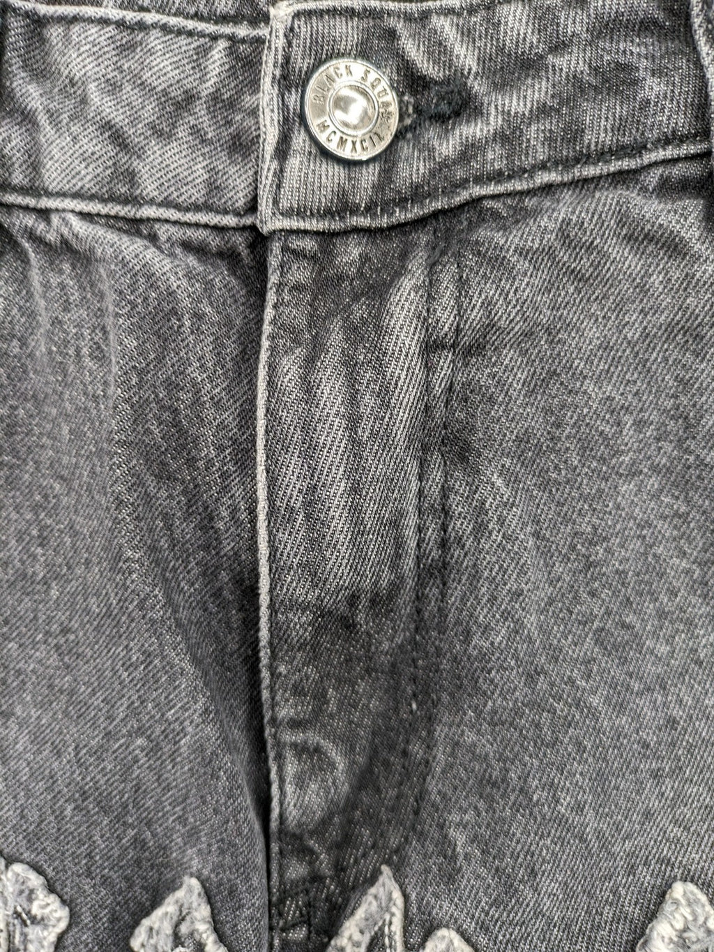 Black Squad black straight jeans with Gothic "Paranoid" lettering and faded finish.