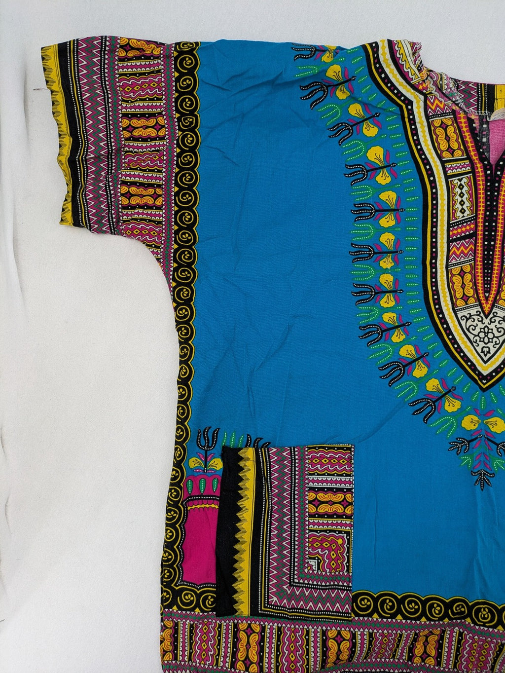 M/L multi Dashiki shirt with vibrant ethnic print on light blue cotton fabric.