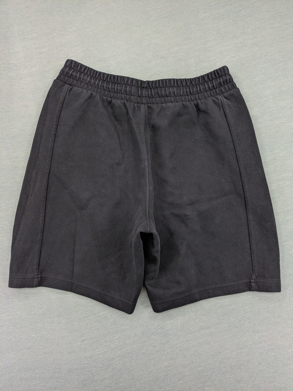 Puma grey sweatshorts featuring Mercedes AMG Petronas logo and elastic waistband.