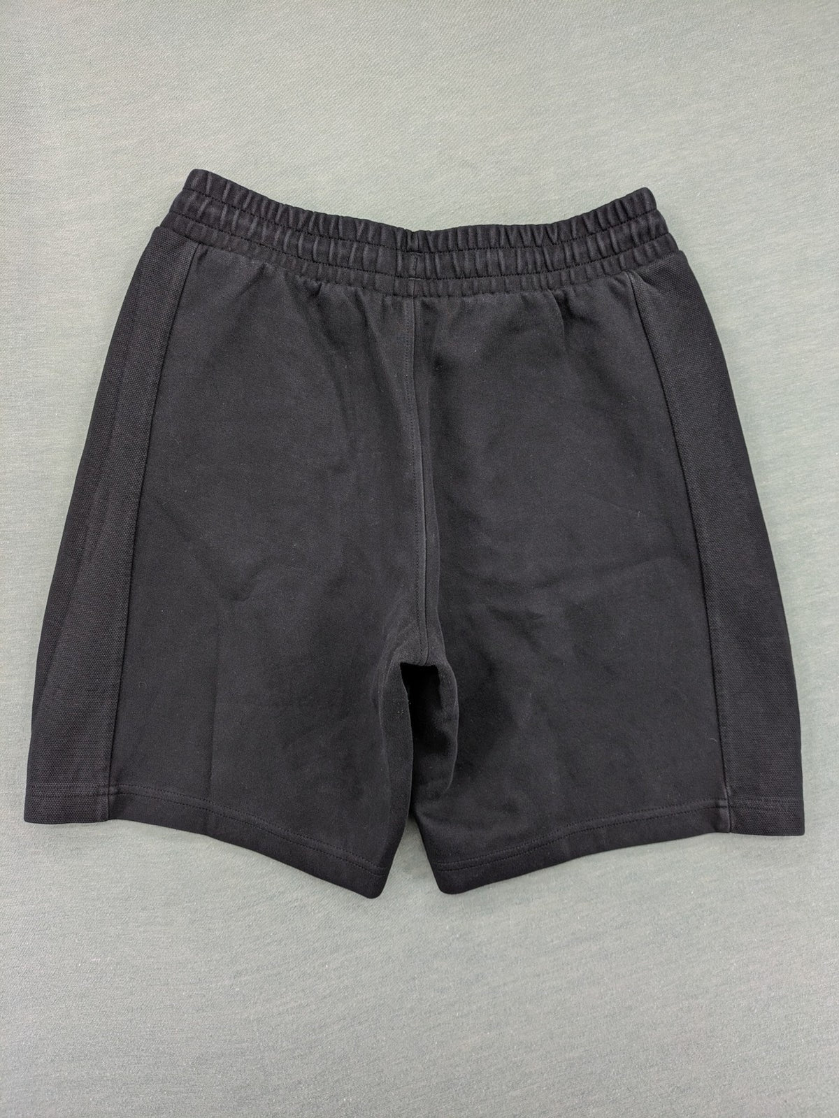 Puma grey sweatshorts featuring Mercedes AMG Petronas logo and elastic waistband.
