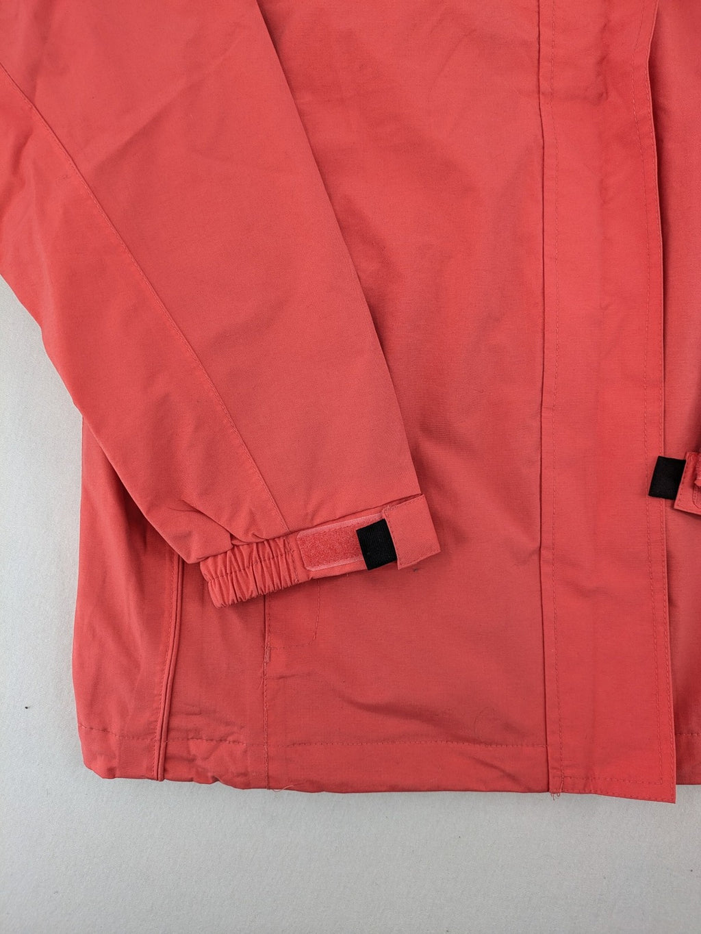 Black Bear black rain jacket with coral pink mesh lining and full zipper.
