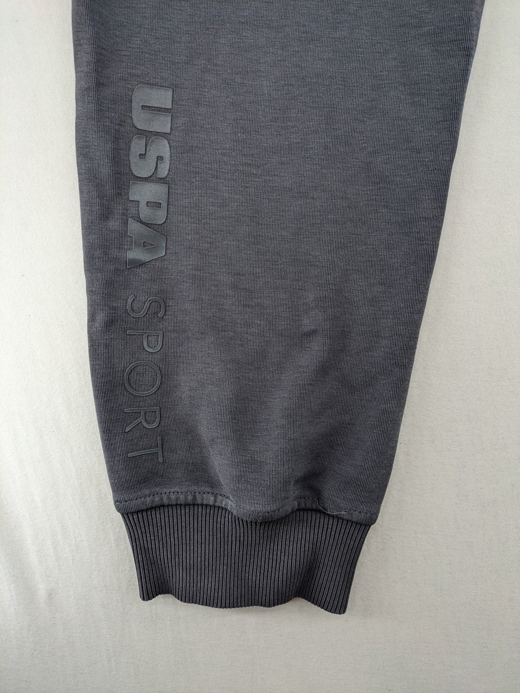 US Polo Assn grey sweatpants with light green drawstring and subtle logo detail.