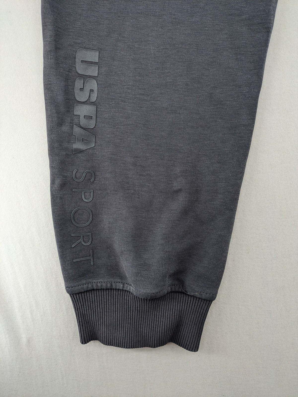 US Polo Assn grey sweatpants with light green drawstring and subtle logo detail.