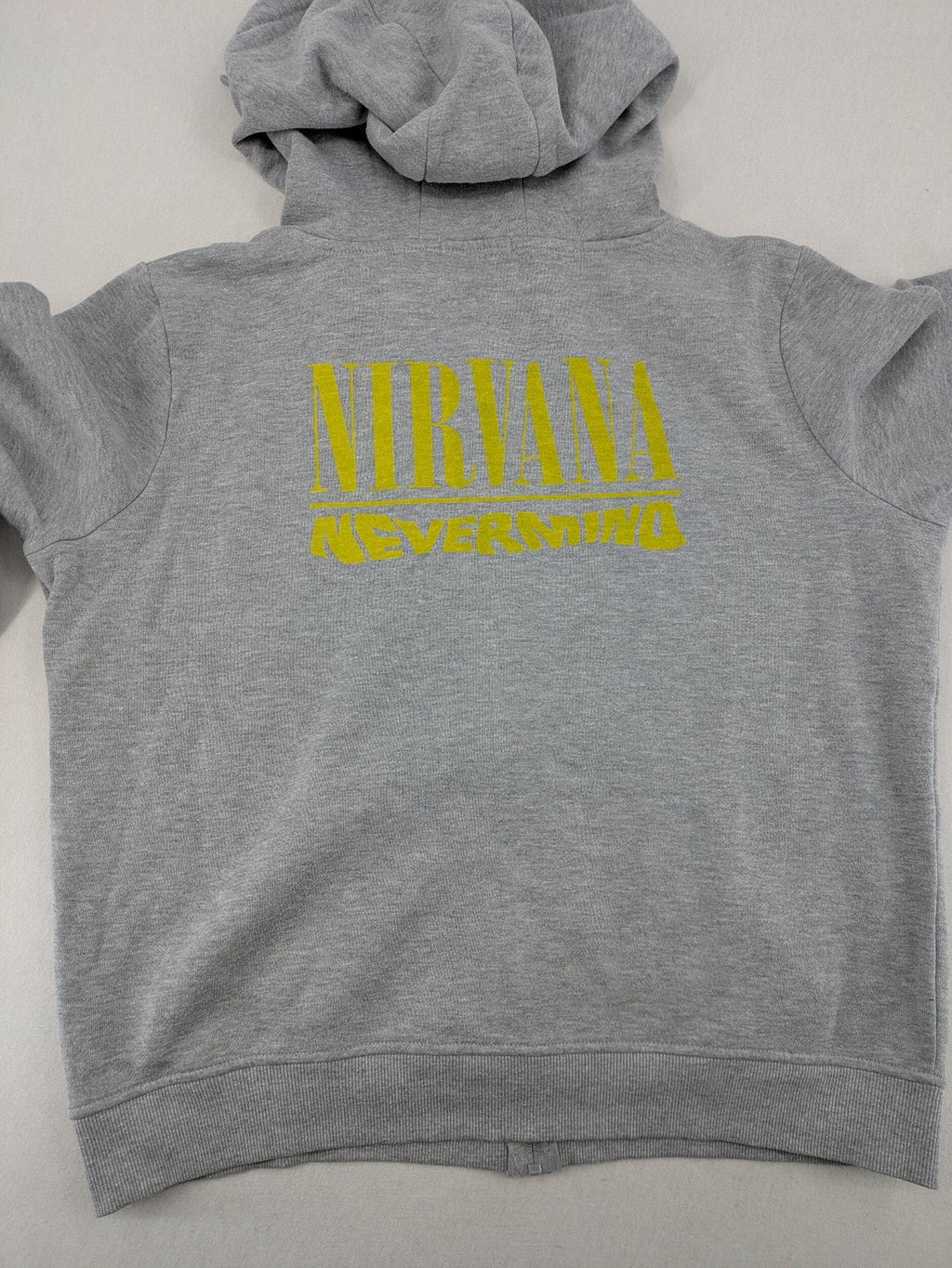 Primark grey zip-through hoodie featuring yellow Smiley logo and Nevermind graphic.