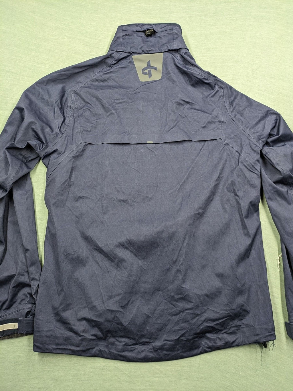 Cross Sportswear orange golf jacket with full zip, high collar, and contrast zipper details.