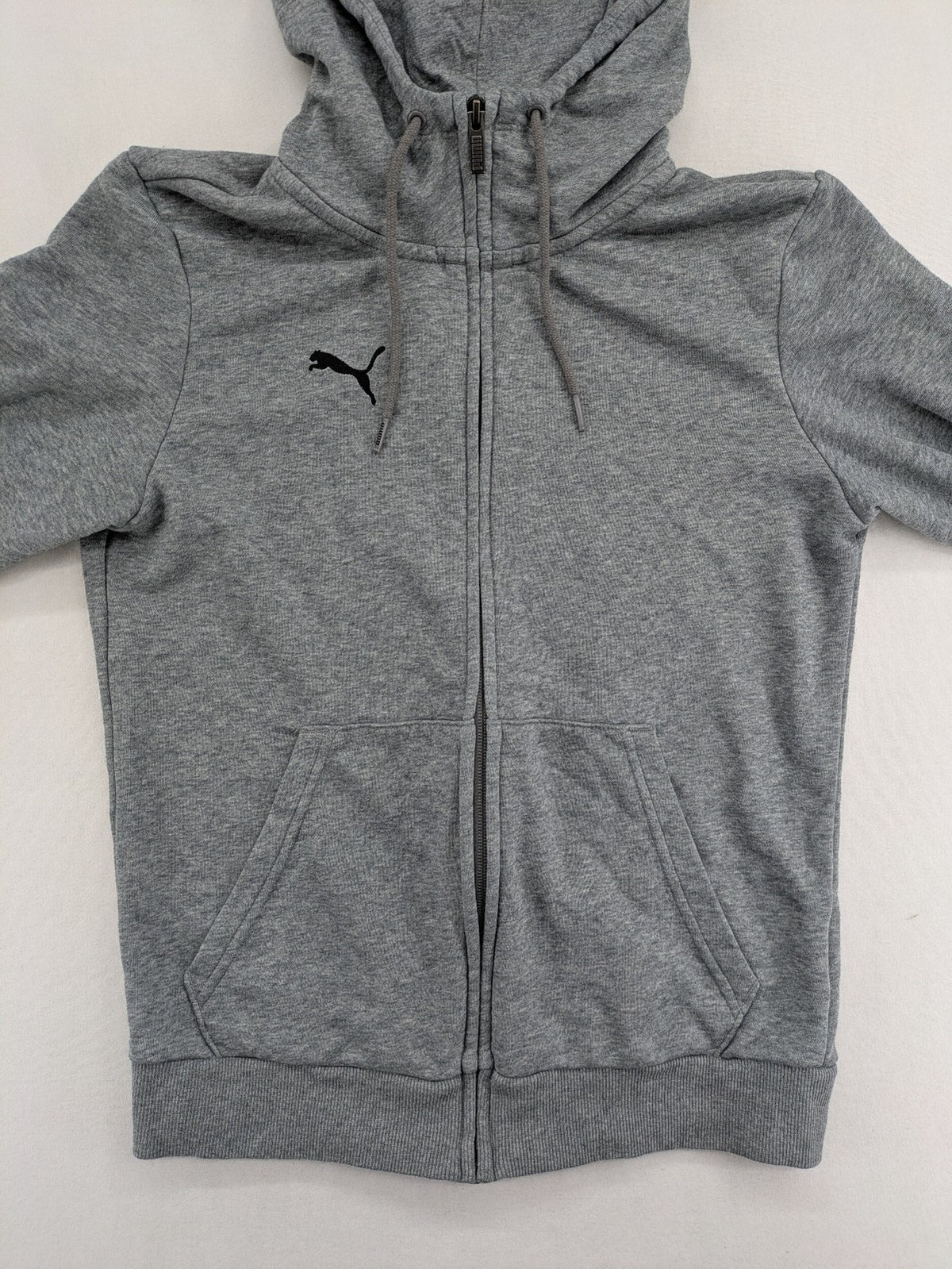 Puma grey full zip hoodie with adjustable drawstring hood and logo detail.
