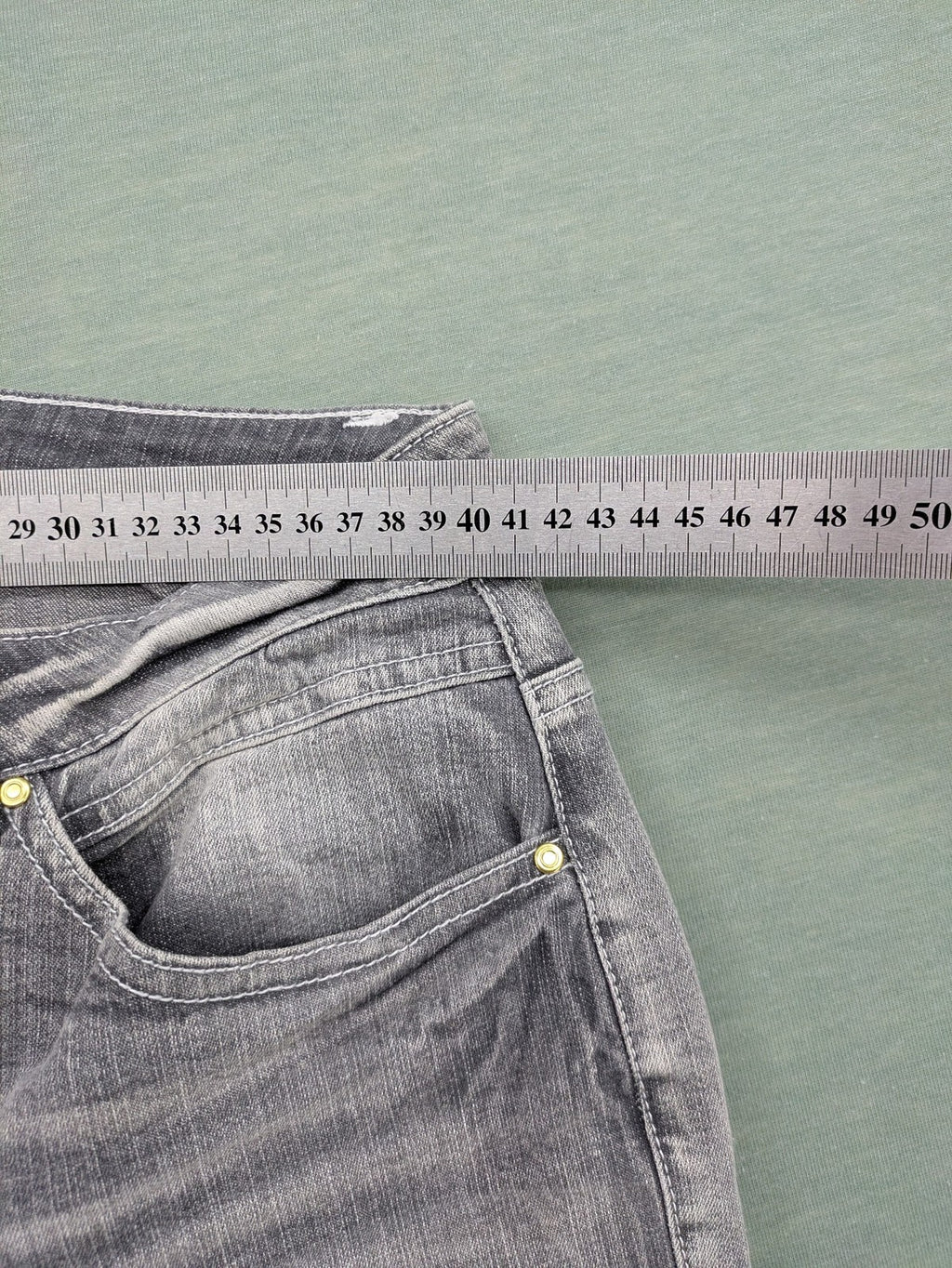 Rick Cardona grey cropped straight jeans with frayed hems and sparkling rhinestone details.