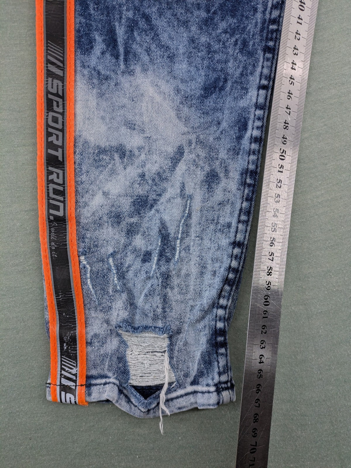 Stark straight jeans multi distressed acid wash with orange patches and side stripes.