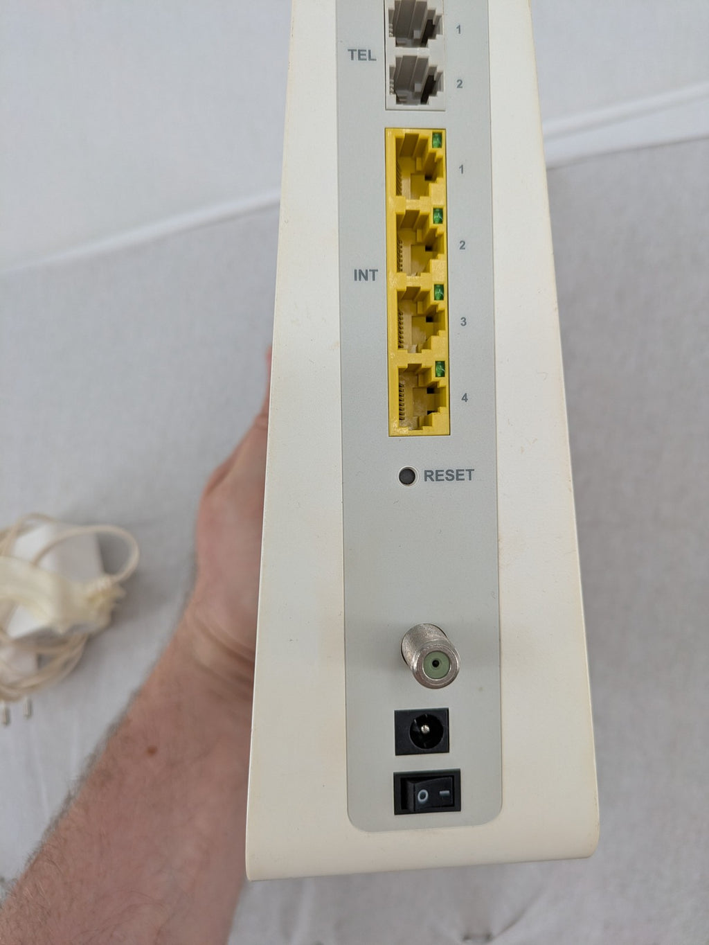 Compal beige WLAN modem router with integrated Wi-Fi and multiple LAN ports.
