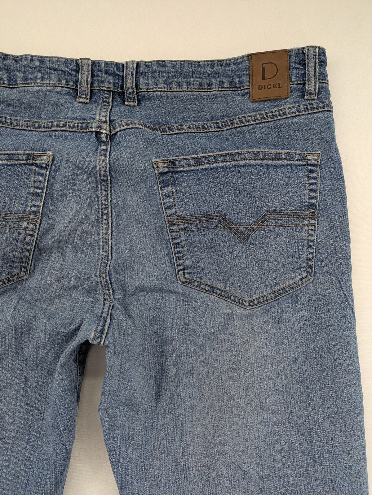 Digel blue straight jeans with classic medium wash and durable cotton denim material.
