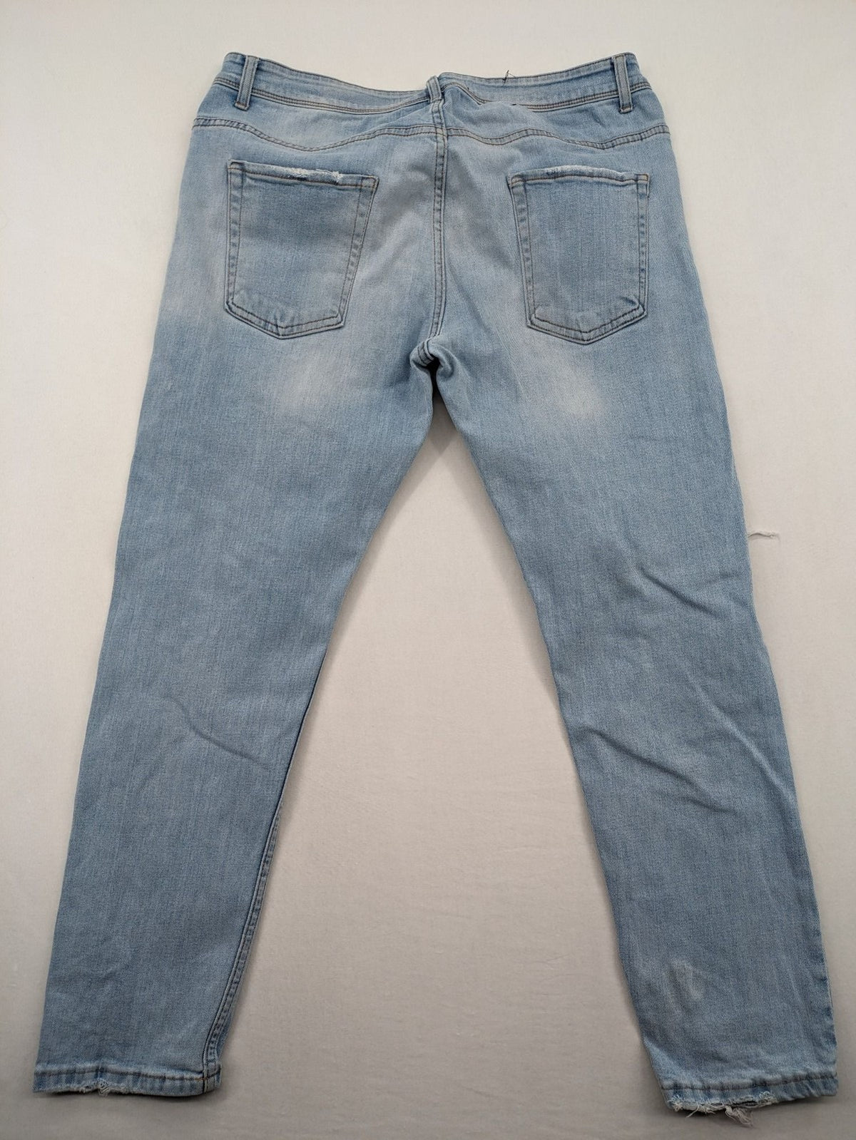 i8 Denim blue straight jeans destroyed look with frayed hems and classic button fly.