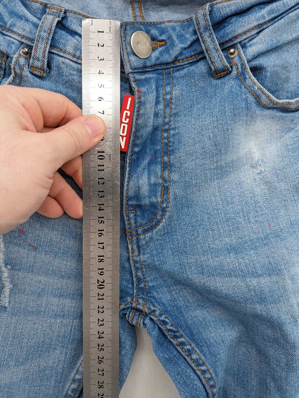 Milano straight jeans light blue distressed with red splatter and extra slim fit.