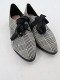 ALDO black and white checkered loafers with decorative bow detail and pointed toe.