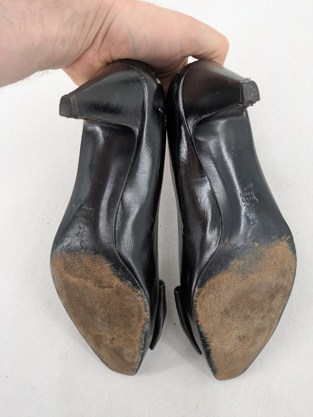 Bruno Magli black high heels leather with grey bow detail and classic silhouette.