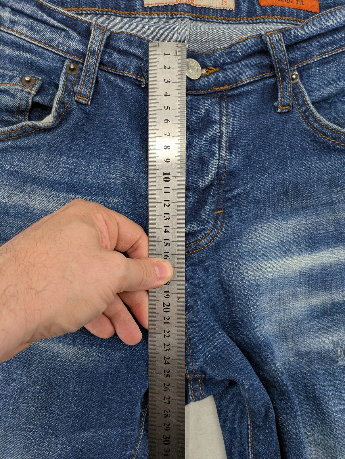 ICON 2 blue slim fit jeans distressed stretch denim with button fly and faded details.