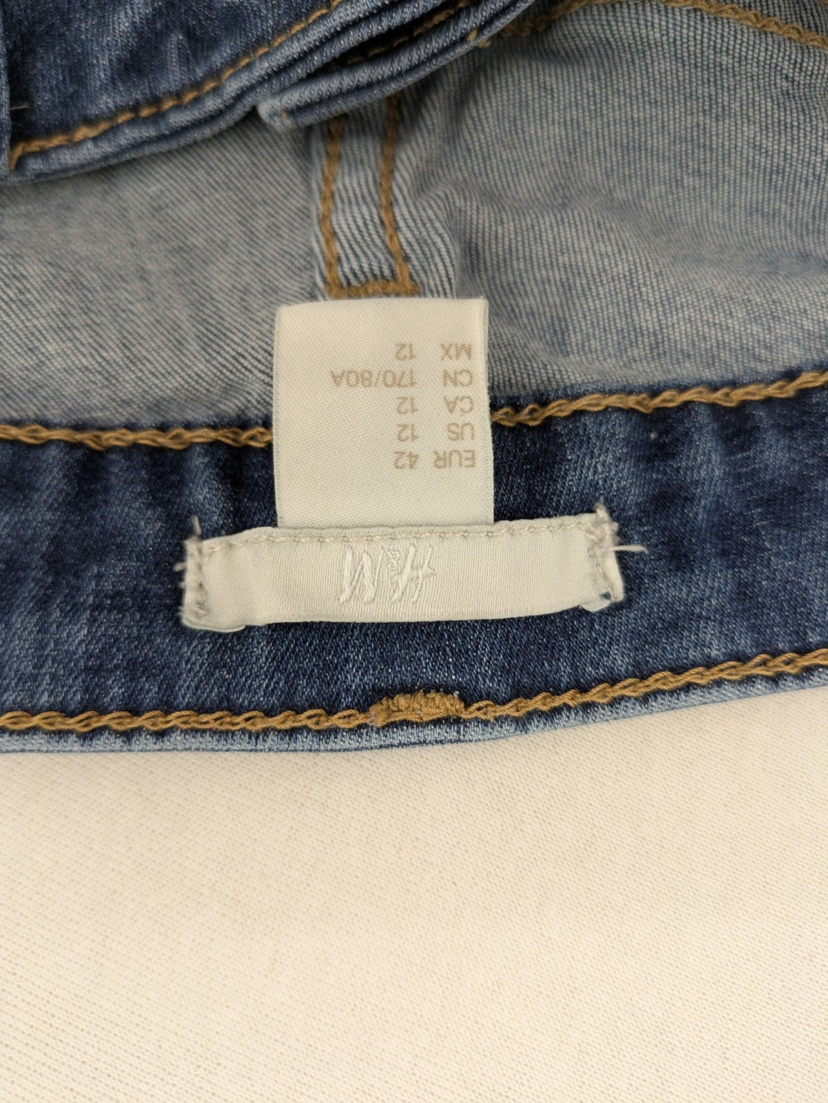 H&M blue skinny jeans with distressed details and comfortable stretch denim material.