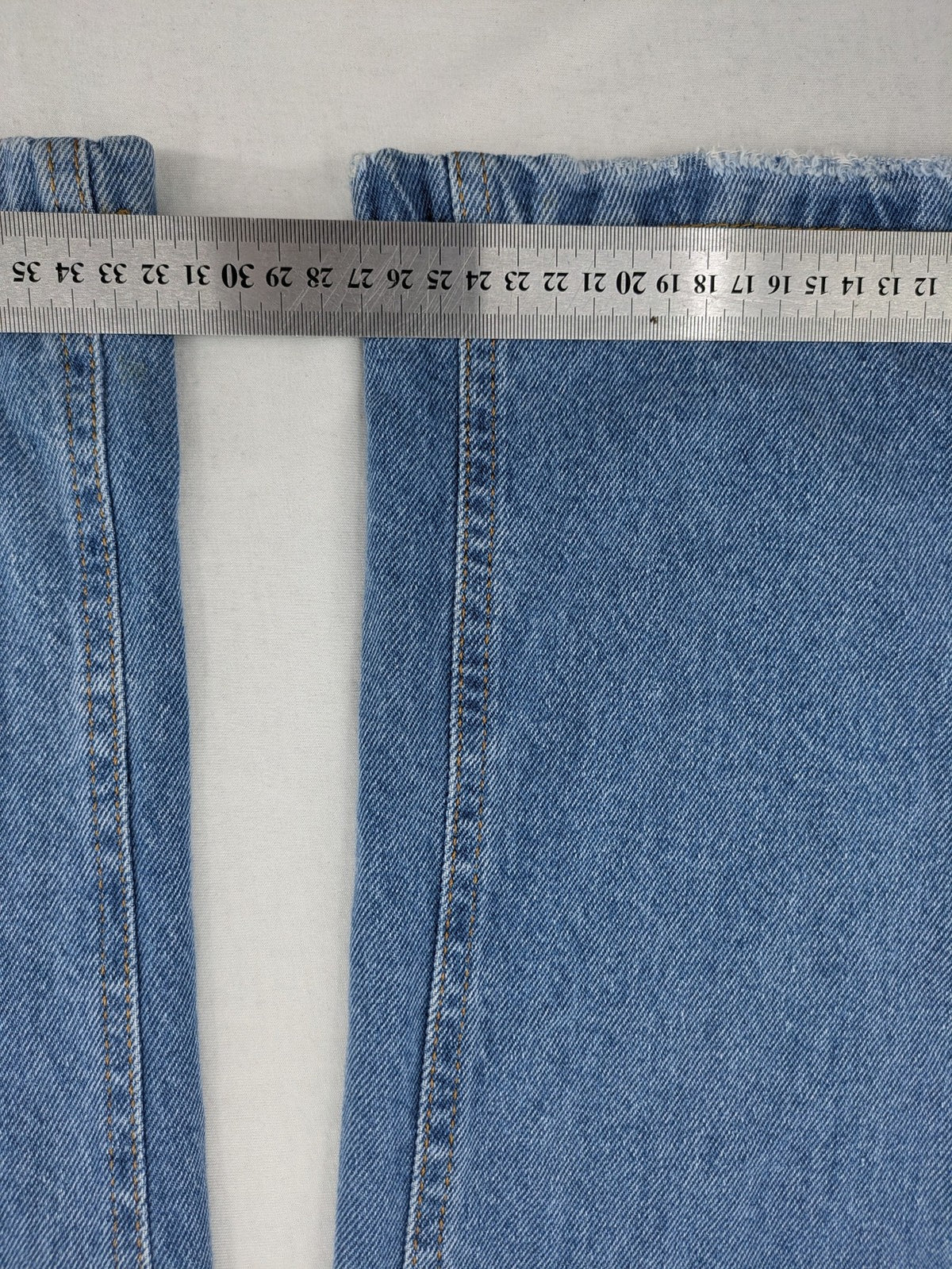 X.LOVE blue high waist wide leg jeans with front pleats and frayed hem.