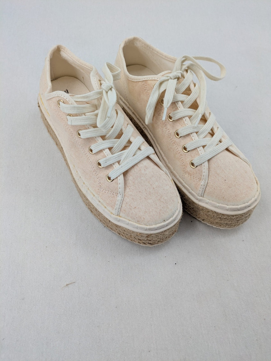 H&M beige espadrille sneakers with jute sole and cream canvas upper.