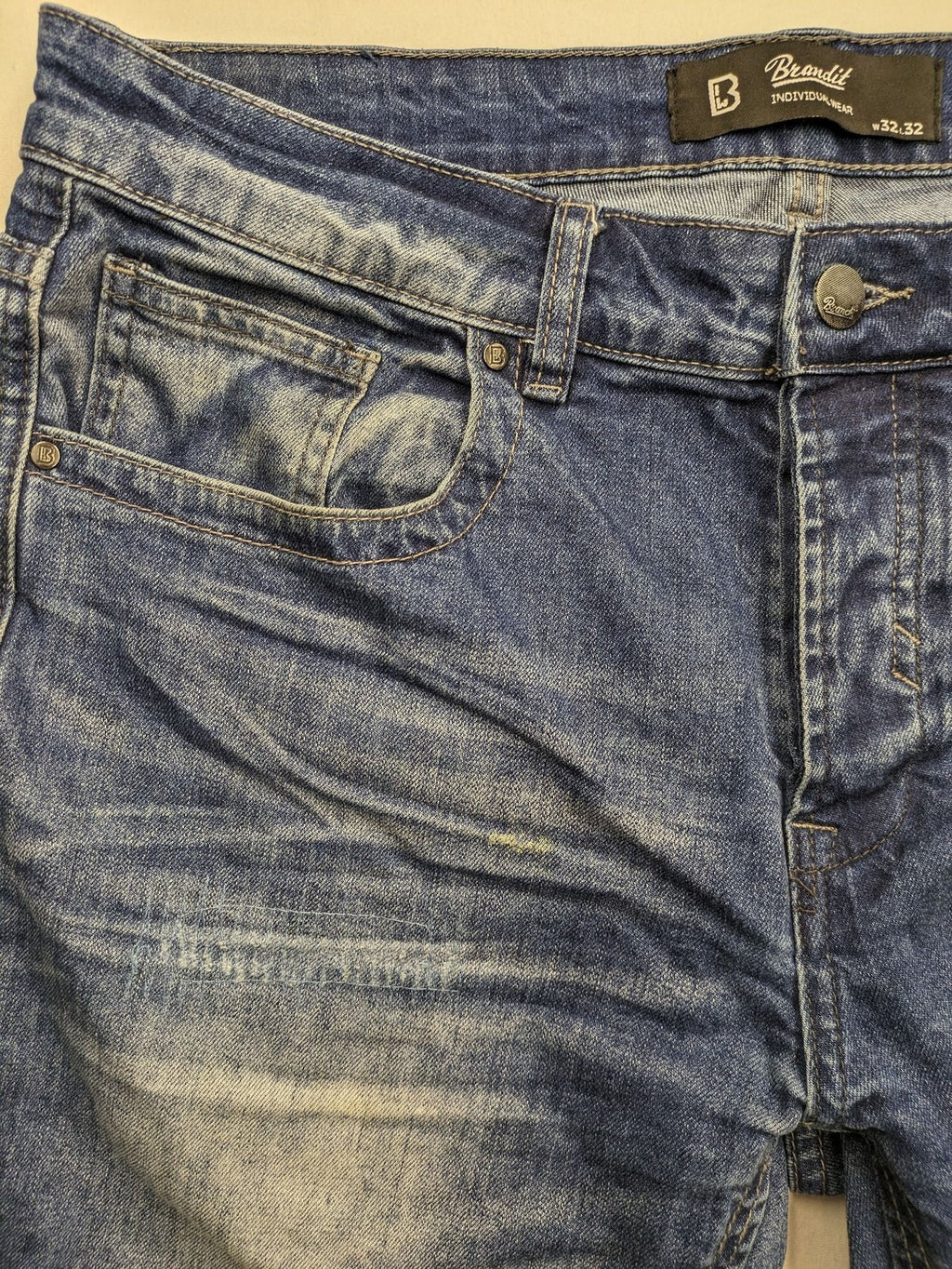 Brandit blue straight jeans with distressed details, button fly, and classic 5-pocket style.