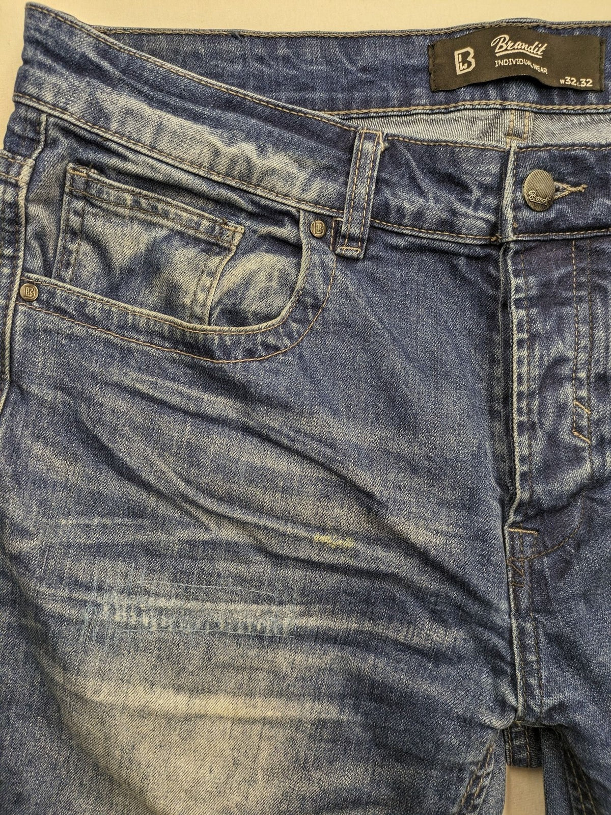 Brandit blue straight jeans with distressed details, button fly, and classic 5-pocket style.