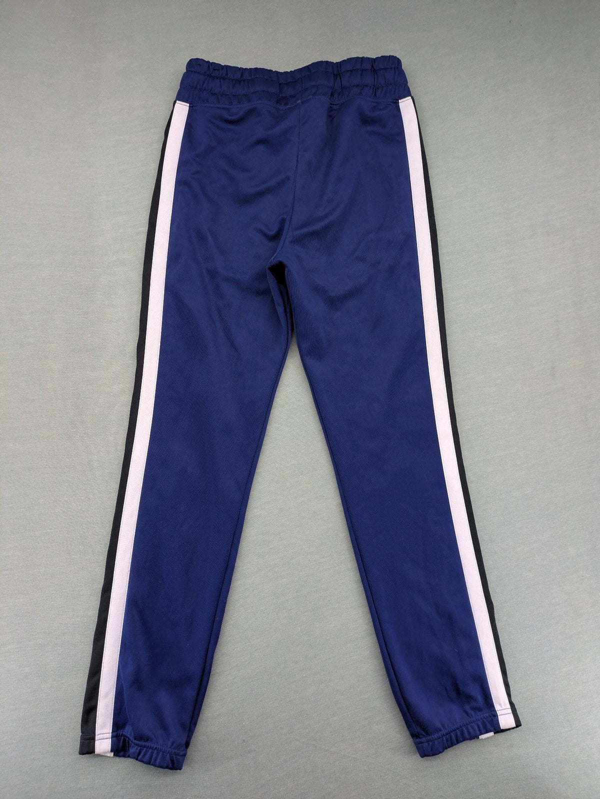 Nike Air blue jogging pants with black and white side stripes, elastic waistband.