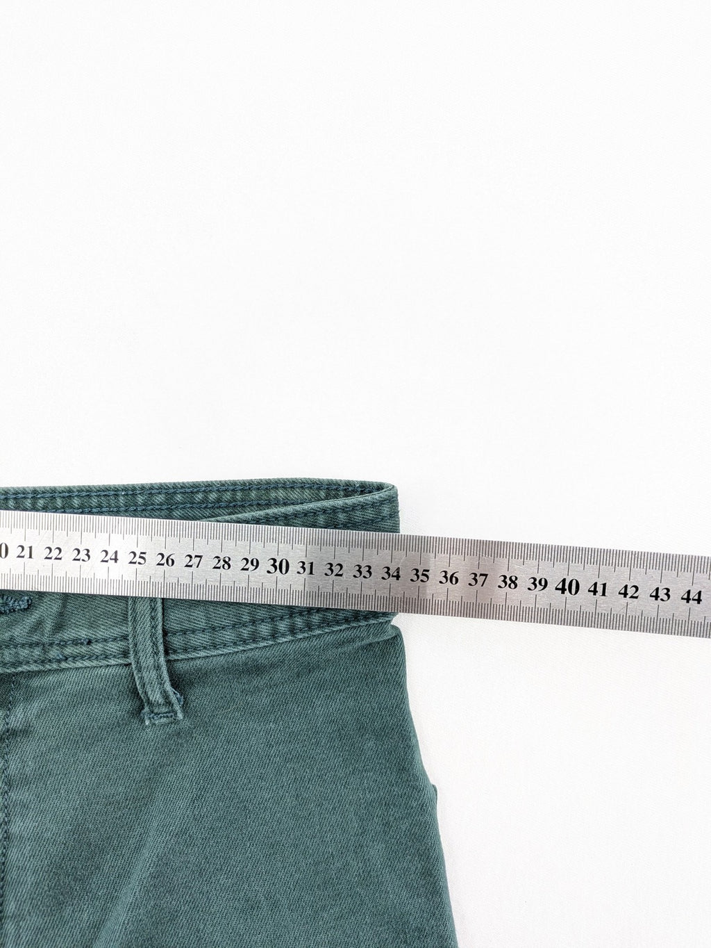 Zara green high waist wide leg jeans with frayed hem and button closure.