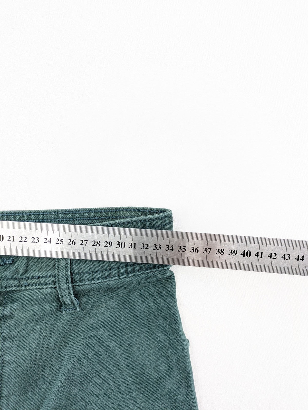 Zara green high waist wide leg jeans with frayed hem and button closure.