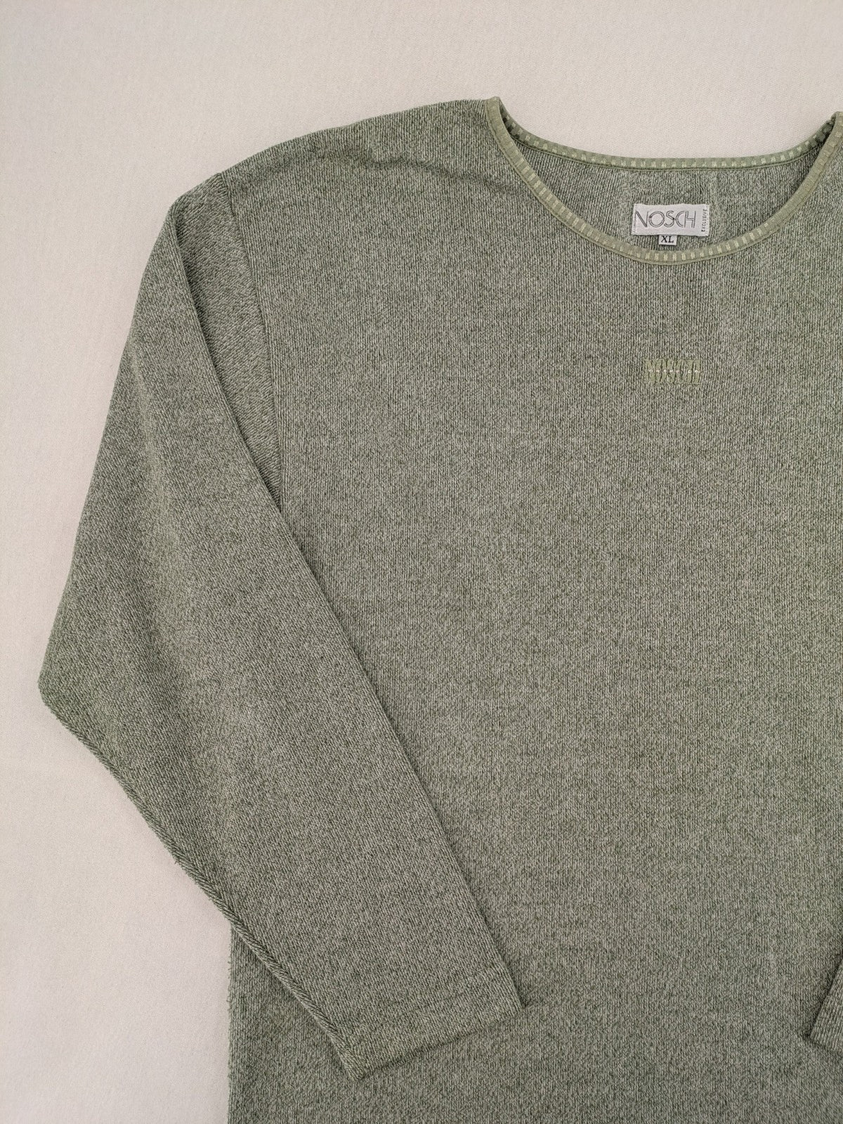 NOSCH knit jumper grey textured fabric with embroidered logo and subtle rhinestone accents.